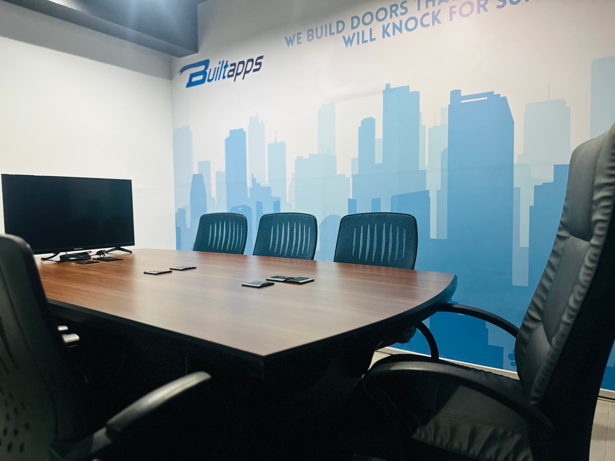 Conference room with Builtapps branding on the wall