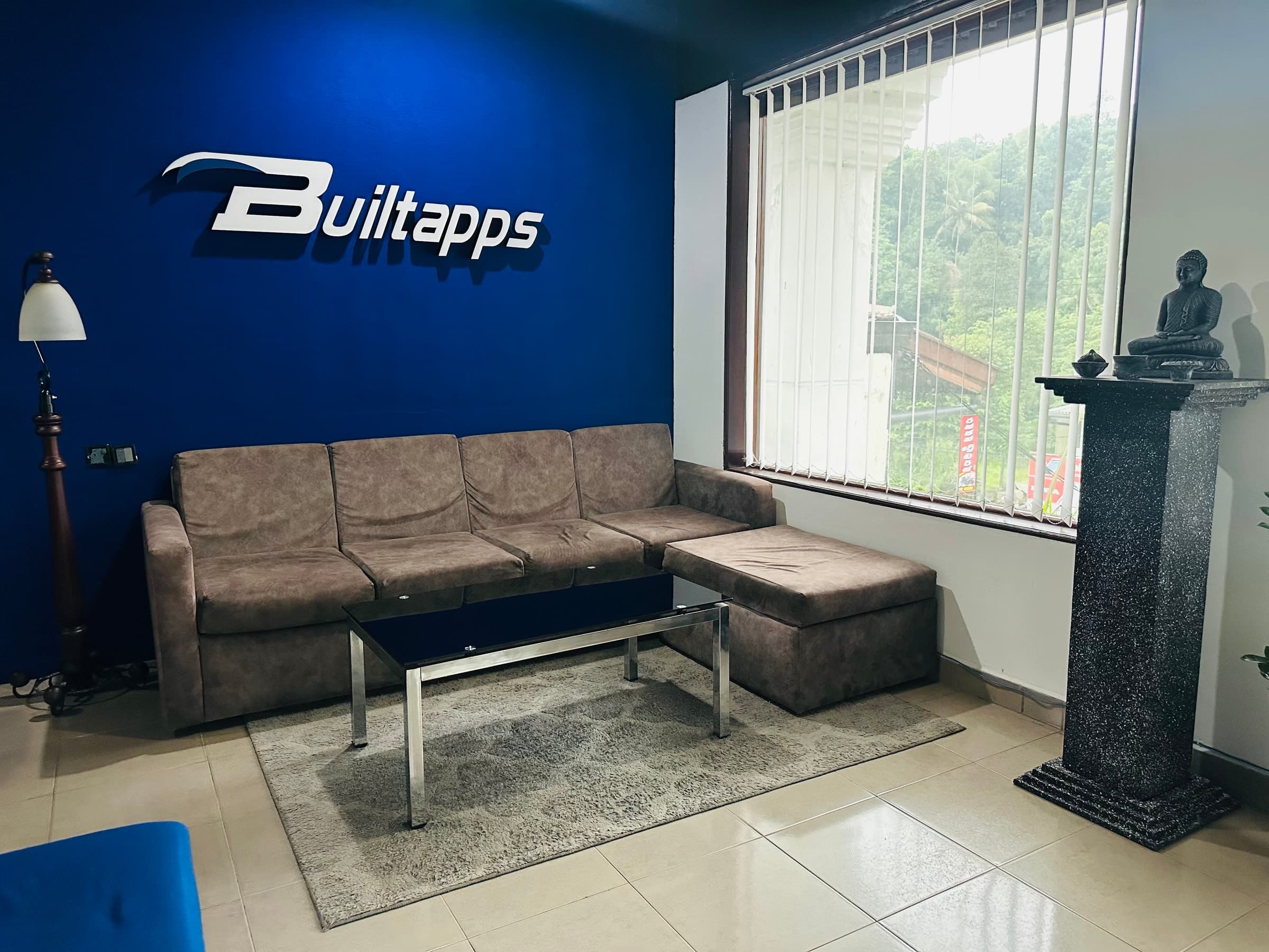 Builtapps reception lounge with logo wall and seating