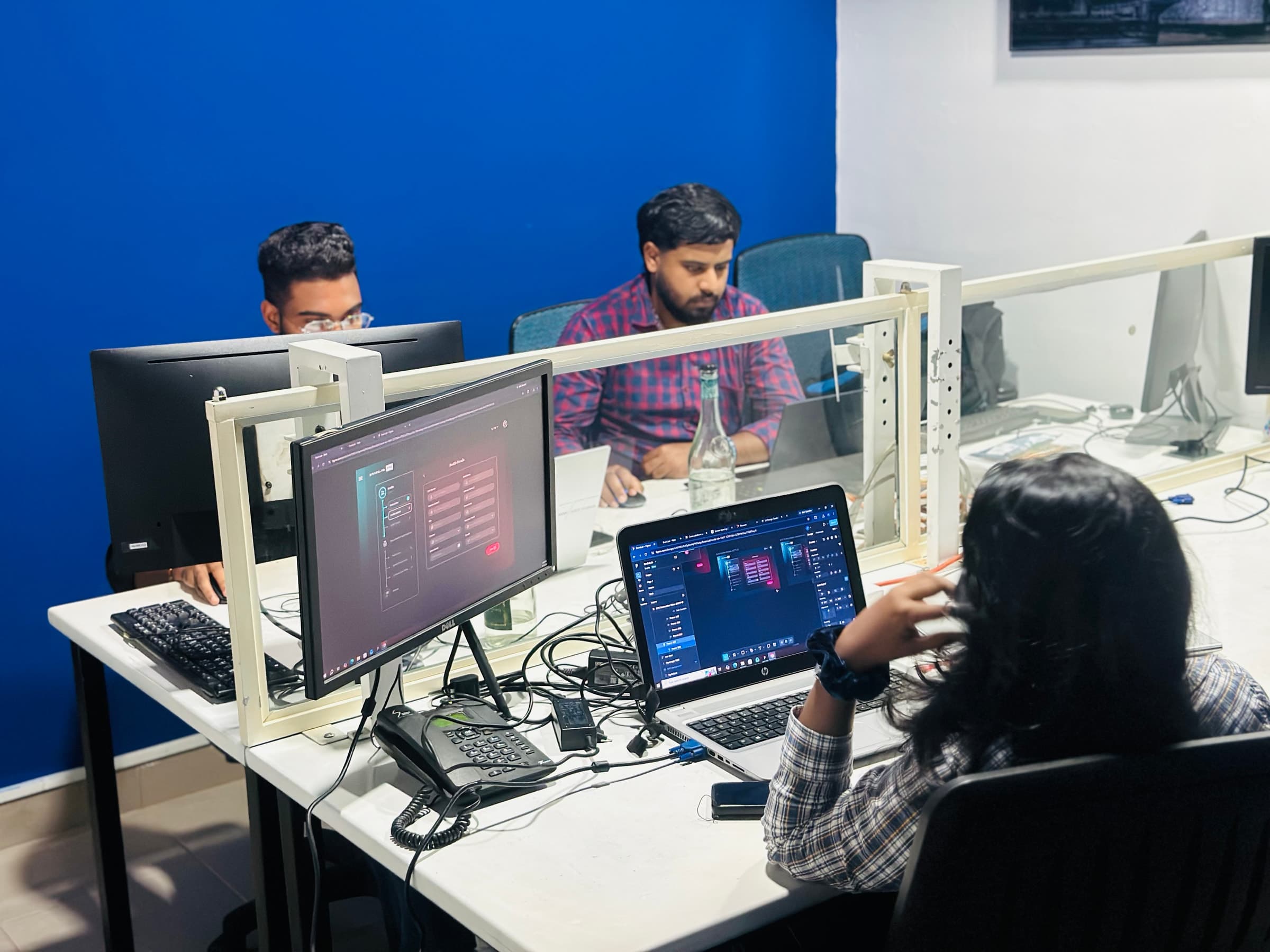 Team collaborating at a shared Builtapps workstation